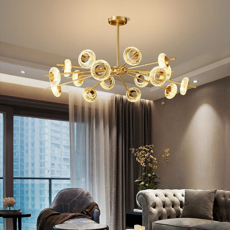 Modern LED chandelier with gold finish. This chandelier features a series of metal rings with crystal shape glass, each embedded with LED lights that cast a radiant sparkle through the glass.