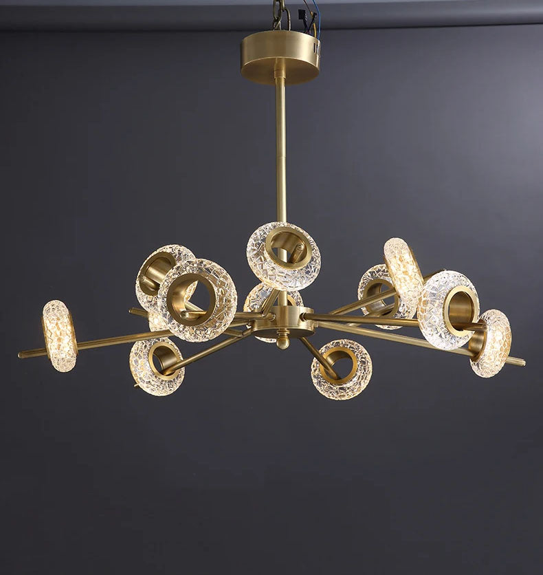 Modern LED chandelier with gold finish. This chandelier features a series of metal rings with crystal shape glass, each embedded with LED lights that cast a radiant sparkle through the glass.